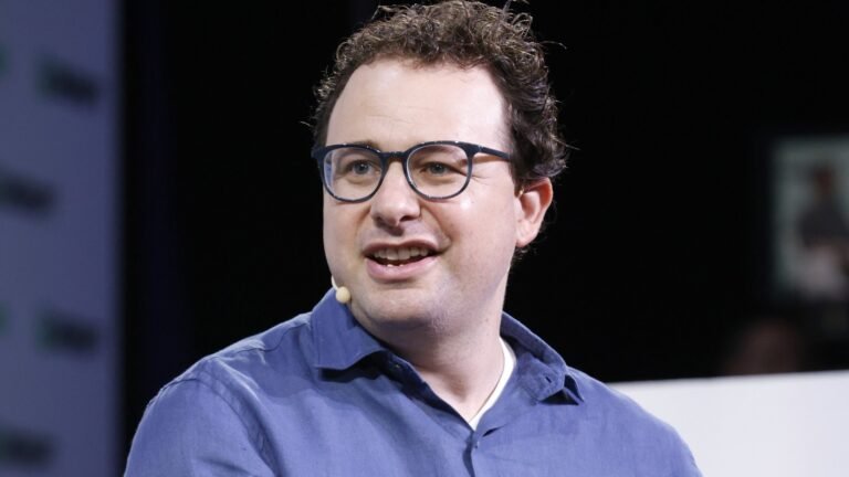 Dario Amodei at TechCrunch Disrupt 2023, in an archival photograph accompanying a Claude subscription comparison.